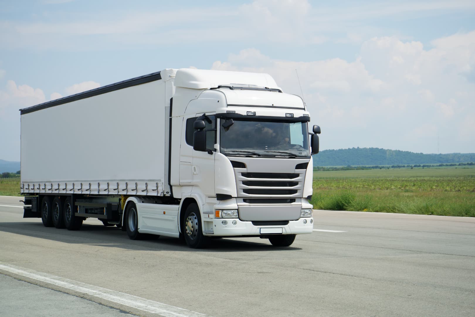 Truck Insurance Claims Process - VIM Cover 1 - VIM | Cover Light commercial truck on highway representing insured transit with VIM Cover’s light truck insurance policy.